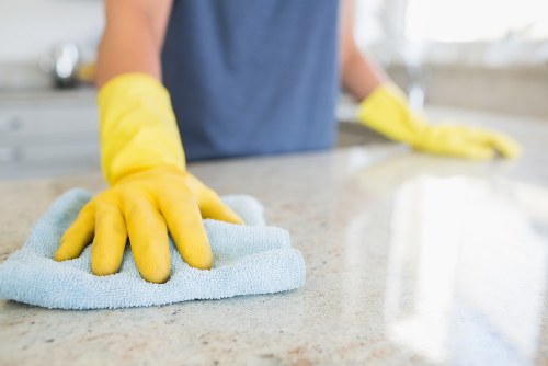 Technician using professional carpet cleaning tools with safety awareness
